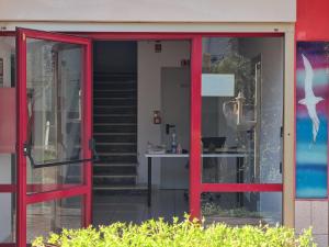 an open glass door of a building with a staircase at Dependance Hotel Marina in Riccione