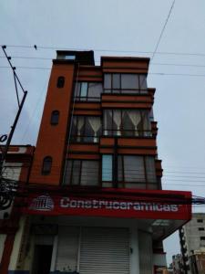 a building with a sign on the front of it at HOTEL OASIS DOS MAX in Ipiales