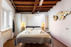 a bedroom with a large bed in a room at Keys of Italy - Erta Canina 36 - Studio in S-Niccolò for 1 or 2 guests in Florence