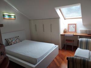 a small bedroom with a bed and a desk at Casa della Elli in Santa Margherita Ligure