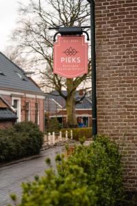 a sign on the side of a brick building at Pieks Noordlaren in Noordlaren