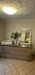 a mirror on top of a dresser in a room at Villa Noa jacuzzi & sauna in Izola