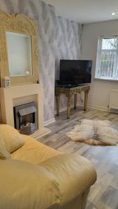 a bedroom with a bed and a mirror and a fireplace at Gortree at Castlerock in Castlerock