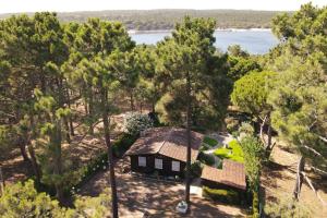 an aerial view of a house in the trees at Casa da Lagoa - House by the Lagoon with Direct Access to the Beach in Sesimbra