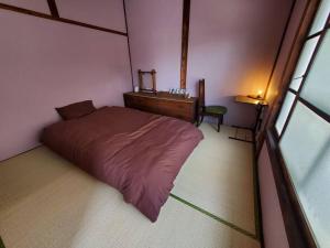 Nogataの商店街の一角にあるちいさな隠れ家　忘覚庵にあるベッド