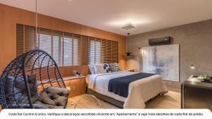 a bedroom with a bed and a swing at Cyclinn Bela Cintra Jardins in Sao Paulo