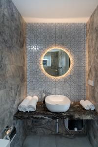 a bathroom with a sink and a mirror at Ukulhas Sands in Ukulhas