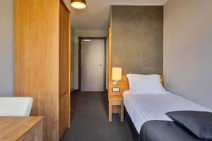Postel nebo postele na pokoji v ubytování Hunzego Hotel