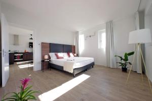a bedroom with a bed and a living room at Siena Hills Apartments in Siena