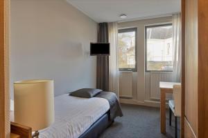 Postel nebo postele na pokoji v ubytování Hunzego Hotel