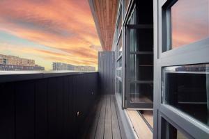 a balcony with a sunset view from a building at Noir by The Heim Residences in Manchester
