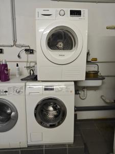 a washing machine and a dryer in a kitchen at Exceptional short-term rental in Düsseldorf