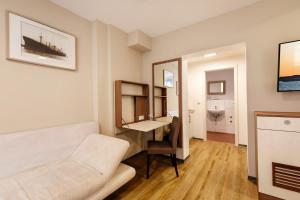 a living room with a white couch and a mirror at Helgolandia Apartments in Helgoland