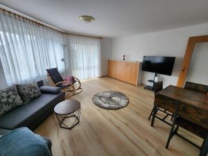 uma sala de estar com um sofá e uma mesa em Ferienwohnung Julija Riedheim em Hilzingen