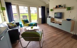 a living room with a couch and a table at Vakantiehuis Saffier in Simpelveld