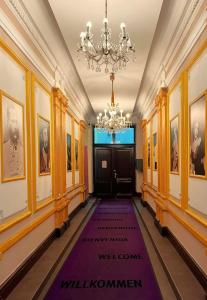 a hallway with a purple carpet in front of a door at Aurellia Serviced Apartments in Vienna