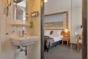 Postel nebo postele na pokoji v ubytování Hunzego Hotel