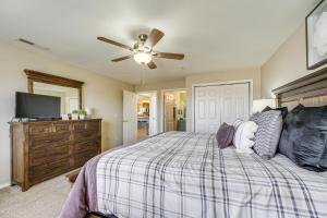 a bedroom with a bed and a ceiling fan at Branson Condo with Pool about 3 Mi to Silver Dollar City in Branson West +33 photos