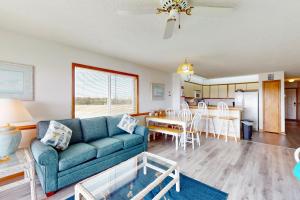 a living room with a couch and a table at Happy Place in Rodanthe