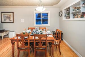 a dining room with a wooden table and chairs at A-Home by chinook mall and Heritage park in Calgary