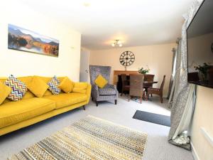 a living room with a yellow couch and a table at 2 Bed in Keswick 28383 in Braithwaite