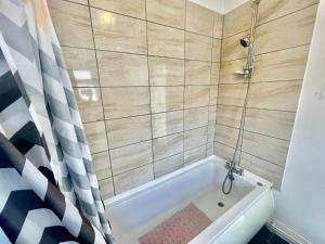 uma casa de banho com banheira e chuveiro em Cozy Home Afan Valley Mountain Retreat - Sleeps -8 em Glyncorrwg