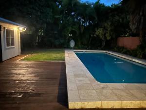 a swimming pool in a backyard at night at Best Vacation rental house close to Kahala Beach ! in Honolulu