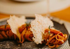 a plate of food with a sandwich and pasta at Hotel Chalé Capitólio in Capitólio