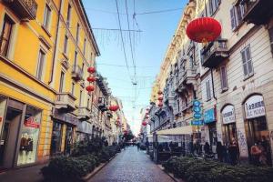 a city street with buildings and red lanterns at Lomat Apartment in Milan