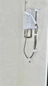 a shower in a bathroom with a blow dryer at Cosy 1 Bed Budget Apartment Near Blackpool City Centre 1 in Blackpool