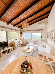 a living room with a couch and a table at Mountain Bliss Guesthouse 1 next to Sougia in Agrilés