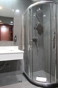 a bathroom with a shower and a sink at Flow Hotel Benguela in Benguela