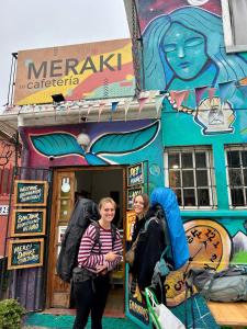 瓦爾帕萊索的住宿－Meraki Hostel - Cerro Alegre - Valparaíso，两个女人站在商店前