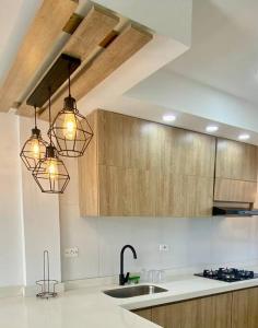 a kitchen with two lights and a sink at Hermoso apartamento céntrico in Mompos