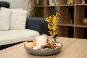 a plate of food on a table with a candle at Apartman A&M in Banská Bystrica