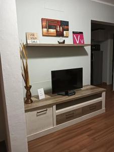 a flat screen tv sitting on top of a entertainment center at Bungalow Esperanza in Costa Teguise
