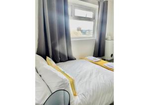 a bed in a room with a window at Pleasant 1 Bed Budget Apartment Near Blackpool City Centre 4 in Blackpool