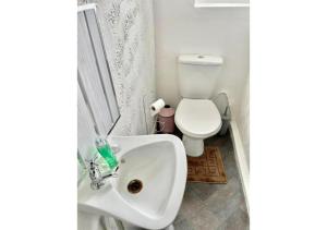 a bathroom with a white sink and a toilet at Pleasant 1 Bed Budget Apartment Near Blackpool City Centre 4 in Blackpool