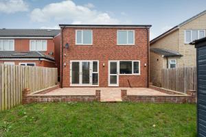 a red brick house with a wooden fence at Entire 4 bed new build detached house in Yorkshire in Batley Carr
