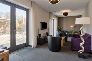 TV a/nebo společenská místnost v ubytování Hunzego Hotel