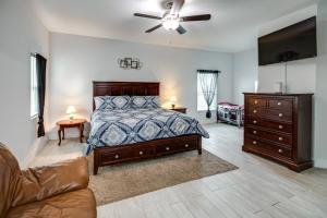 a bedroom with a bed and a dresser and a couch at Lanai, Private Pool Lehigh Acres Home in Lehigh Acres +19 photos