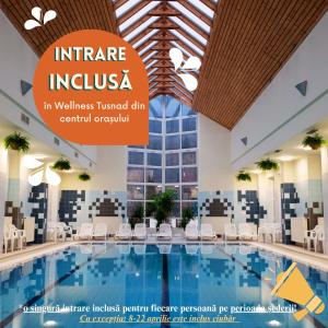 a pool in a hotel with a sign that reads insurance insurance in wellness turned down at Fortuna Eco - Boutique Hotel in Băile Tuşnad