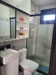 a bathroom with a toilet and a sink and a shower at Praia do Forte / Studio in Mata de Sao Joao