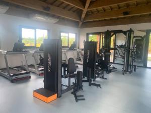 a room with a gym with several treadmills and machines at Praia do Forte / Studio in Mata de Sao Joao