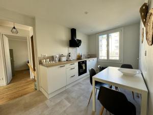 a kitchen with a table and a dining room at Le 122 - Parking in Rodez