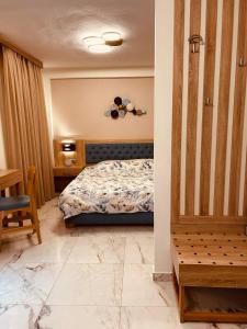 a bedroom with a bed and a table and a chair at Marble House in Kavála