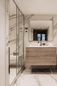 a bathroom with a sink and a mirror at HIGHSTAY - Luxury Serviced Apartments - Place Vendôme in Paris
