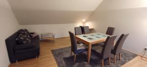 a dining room with a table and chairs at Meine Ferienwohnung Seeburg 1 in Seeburg