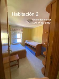 a room with two beds and a door with the words halitation ultra o at Beis House in Las Palmas de Gran Canaria