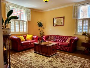 a living room with two red couches and a coffee table at Trinity View YORK in York